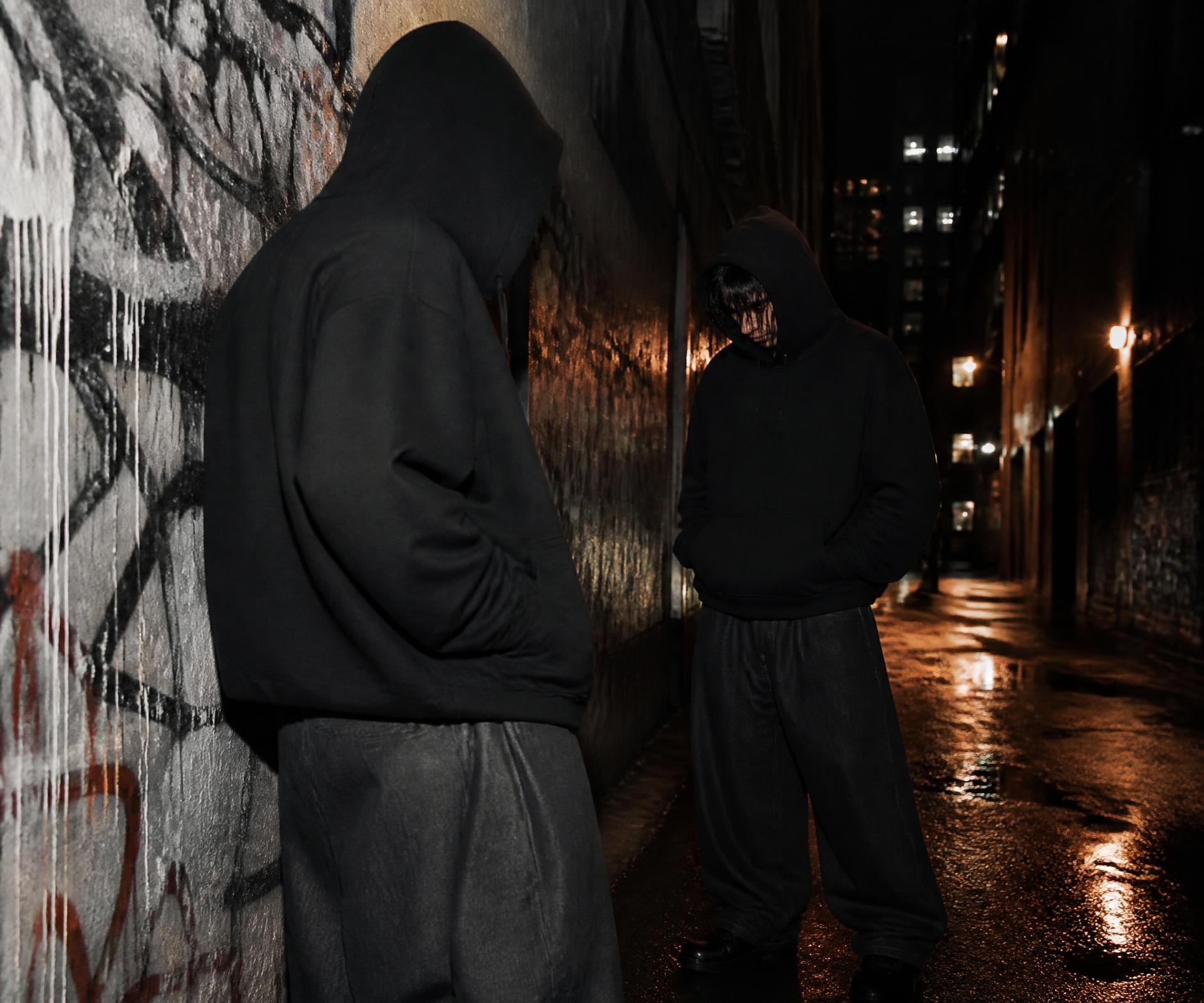 Placeholder campaign image: two figures in oversized black hooded sweats in a Melbourne laneway at night