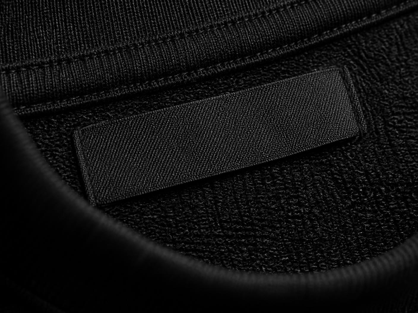 Placeholder detail image: heavyweight black cotton, seam stitching and a blank woven label